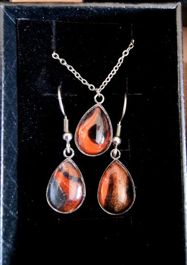 Stainless steel tear drop pendant and earrings containing parts of original art orange and black with gold shimmer