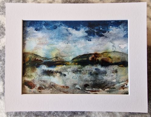 Moody Blues Watercolour landscape in blues and muted earth tones depicting dark cloud sky with reflection of clouds in a pond in a hilly landscape.