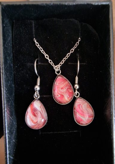 Stainless steel tear drop pendant and earrings containing parts of original art in  pearl and pink.