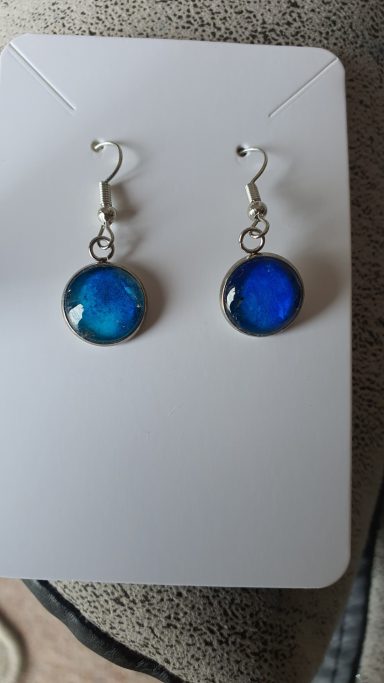 Silver colour round drop earrings containing deep blue and silver gilded original art work