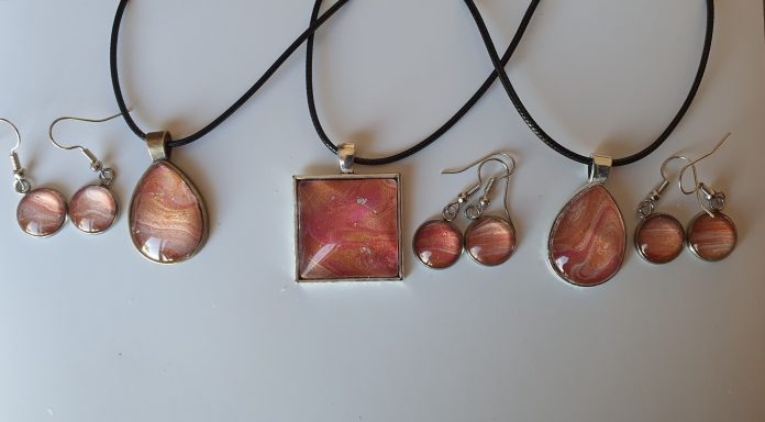 Handmade earings and necklaces  with teardrop and square pendants containing parts of original art in golds and muted pinks