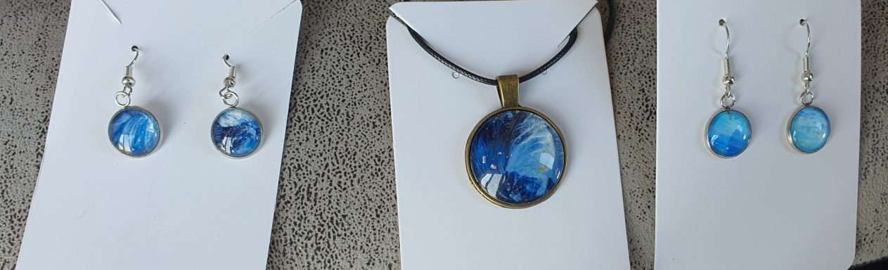 Round bronze pendant and silver round drop earrings containing original dark blue and gold acrylic painting