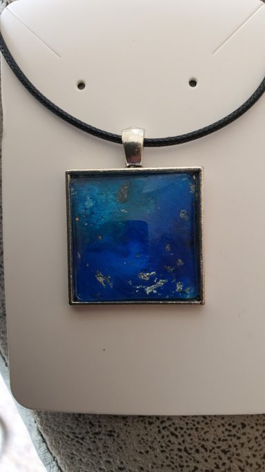 Silver square pendant containing deep blue and silver gilded original art work