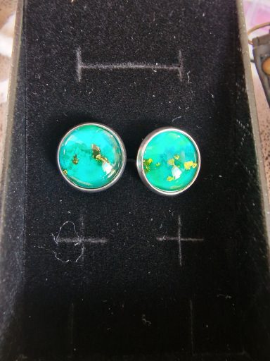 Pair of silver cufflinks containing green and gold art under glass
