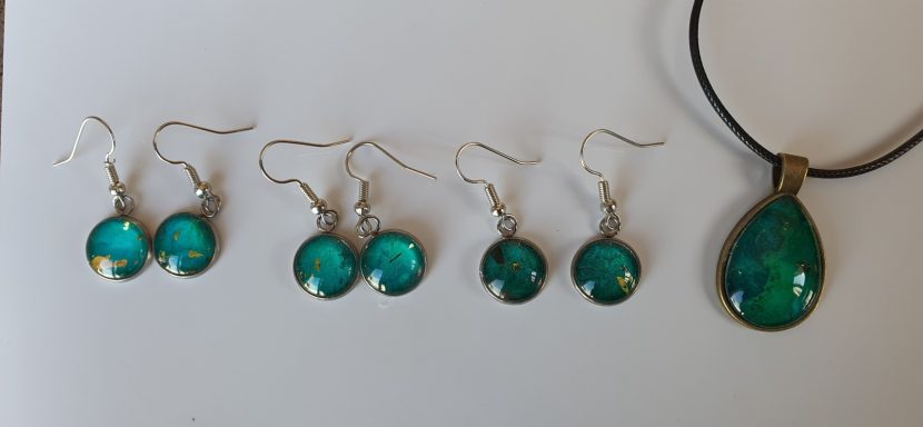 Silver colour round drop earrings containing containing dark green and gold gilded original art work