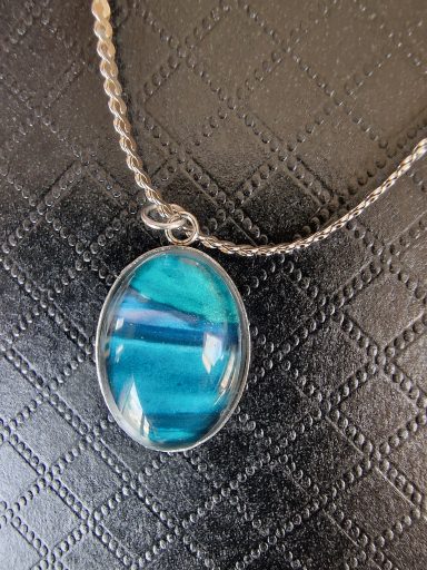 Sterling silver oval pendant on sterling silver flat chain, pendant contains muted purple and turquoise artwork