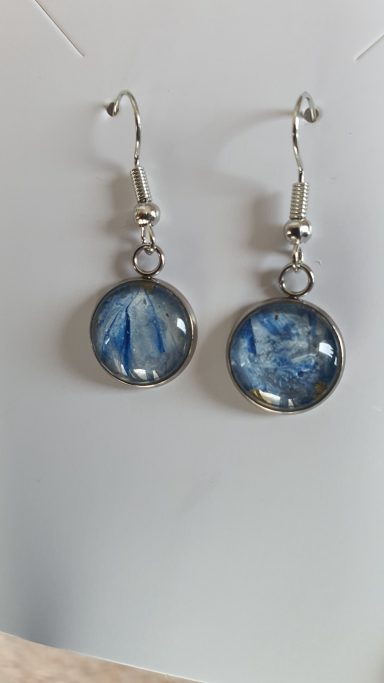 Silver round drop earrings containing original moonlight pearl and dark blue from original art work