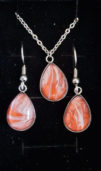 Stainless steel tear drop pendant and earrings containing parts of original art in bronze, pearl and muted pink.
