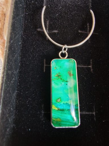 Sterling silver rectangular pendant on sterling silver snake chain, pendant contains green and gold art
